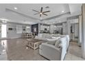 Bright living room featuring tile floors, recessed lighting, and an open layout to dining and kitchen at 206 Santarem Cir, Punta Gorda, FL 33983