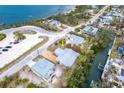 Aerial view of a charming home near the bay, surrounded by lush greenery and neighboring houses at 231 Winson Ave, Englewood, FL 34223