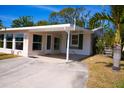 Well-maintained home features a covered carport and sunny patio for relaxed outdoor living at 2521 Clipper Ship Way, Sarasota, FL 34231