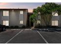 Condo exterior featuring stairs to the units, parking, and green landscaping with a mature tree at 2717 Hidden Lake Blvd # C, Sarasota, FL 34237