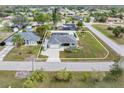 Aerial view of a property with a fenced backyard and a well-maintained lawn and nearby homes at 3101 Brooklyn Ave, Port Charlotte, FL 33952