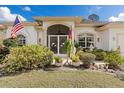 Inviting front entrance with decorative ironwork, lush greenery, and decorative features at 3816 N Cranberry Blvd, North Port, FL 34286