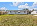 Single-story home with a well-maintained lawn and covered parking, providing both comfort and convenience at 5211 Prime Ter, North Port, FL 34286