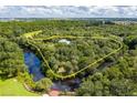 Aerial view of the property that shows the land and home surrounded by a river and lush landscape at 5601 Taylor Rd, Punta Gorda, FL 33950