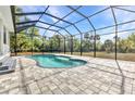 Backyard pool with a paved patio, with beautiful views and blue skies at 5601 Taylor Rd, Punta Gorda, FL 33950