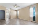 Neutral bedroom with tile flooring, ceiling fan, and lots of natural light at 6938 Rabbit Ave, North Port, FL 34291