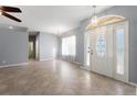 Spacious living room featuring neutral walls, large windows, and tile floors throughout at 6938 Rabbit Ave, North Port, FL 34291