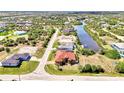 Aerial view of home showcasing its prime location on a canal with private dock and serene surroundings at 10393 Harlingen St, Port Charlotte, FL 33981