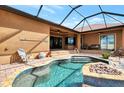 Gorgeous pool with decorative stone accents, surrounded by a brick patio, perfect for poolside relaxation at 10393 Harlingen St, Port Charlotte, FL 33981