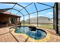 Relaxing screened-in pool with a beautiful brick deck perfect for enjoying sunny days and outdoor living at 10393 Harlingen St, Port Charlotte, FL 33981