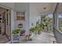 Inviting screened porch adorned with potted plants and charming decor, perfect for relaxing outdoors at 1350 Old Oak Trl, Port Charlotte, FL 33948