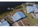 An aerial view of a canal-front home with private boat dock and lush landscaping at 137 Poinsettia Ne Cir, Port Charlotte, FL 33952