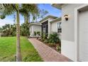 Side view of the home's exterior showcasing the brick walkway, landscaping, and architectural details at 1470 Atwater Dr, North Port, FL 34288