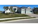 Gorgeous one story home with a black roof, and a two-car attached garage, complemented by meticulously maintained landscaping at 15155 Scarlet Oak Ct, Punta Gorda, FL 33955