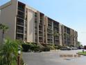 Exterior view of the condo building showing multiple units with screened balconies and parking at 21405 Olean Blvd # 605, Port Charlotte, FL 33952