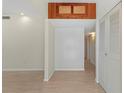 Bright hallway with hardwood floors, leading to other rooms, next to a closet and wooden accent at 2255 Easy St, Port Charlotte, FL 33952