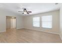 Open living space with wood floors, natural light from bright windows, and an overhead ceiling fan at 2255 Easy St, Port Charlotte, FL 33952