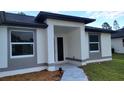A front entry shows the protected entrance and walkway to the front door at 23490 Macbeth Ct, Punta Gorda, FL 33980