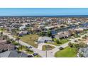 Expansive aerial shot of homes situated on canals, showcasing the waterfront community and sunny skies at 2501 Rio Grande Dr, Punta Gorda, FL 33950