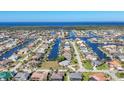 Stunning aerial view of waterfront homes along canals with ocean backdrop on a sunny day at 2501 Rio Grande Dr, Punta Gorda, FL 33950