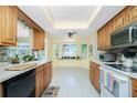 Bright kitchen featuring light oak cabinetry, white countertops, and a bay window over the sink area at 2550 Ivanhoe St, Port Charlotte, FL 33952