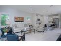 A bright living room that offers an open concept layout with the kitchen, making it the perfect place to entertain at 27500 Janzen Ct, Englewood, FL 34223