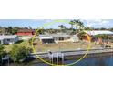 Aerial view of the property with a waterfront backyard, including a private dock and canal access at 3100 Magnolia Way, Punta Gorda, FL 33950