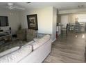 Inviting living room with hardwood floors, comfortable seating, and a view into the dining area at 3209 Sunrise Trl, Port Charlotte, FL 33952