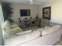 Inviting living room with hardwood floors, comfortable seating, and a large window at 3209 Sunrise Trl, Port Charlotte, FL 33952