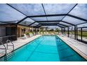 Enclosed swimming pool area with lounge chairs, providing a relaxing and private recreational space at 3256 White Ibis Ct # 13B, Punta Gorda, FL 33950