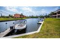 Picturesque waterfront view with a boat docked, offering a serene and accessible boating experience at 3256 White Ibis Ct # 13B, Punta Gorda, FL 33950