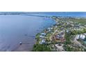 Stunning aerial view of waterfront property with direct bay access, surrounded by lush landscaping and a pristine shoreline at 4381 Northshore Dr, Punta Gorda, FL 33980