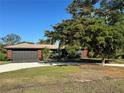 Charming single-story home with a gray garage and a well-manicured lawn under a clear blue sky at 4381 Northshore Dr, Punta Gorda, FL 33980