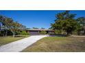 Charming single-story home with a spacious front yard and a long driveway at 4381 Northshore Dr, Punta Gorda, FL 33980
