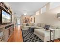 Spacious living room with a comfortable sectional sofa, tv and hardwood floors at 5017 Hanging Moss Ln, Sarasota, FL 34238