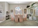 Formal dining room featuring a chandelier, large window, and elegant furnishings for sophisticated gatherings at 507 Monaco Dr, Punta Gorda, FL 33950