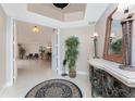 Entrance foyer with tile flooring, decor, and access to an open floorplan at 87 Vivante Blvd # 8732, Punta Gorda, FL 33950