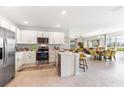 Modern kitchen with white cabinets, stainless steel appliances, and an open layout at 9459 Sunbeam Cir, Punta Gorda, FL 33950