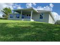 A covered patio and well-kept lawn add appeal to this lovely single-story home at 13902 Allamanda Cir, Port Charlotte, FL 33981