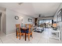 Bright living room featuring tile floors, comfortable seating, and sliding glass doors to the outside at 1423 Mediterranean Dr # C, Punta Gorda, FL 33950