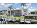 Condo's outdoor space with dock, landscaping, and waterfront view at 1423 Mediterranean Dr # C, Punta Gorda, FL 33950