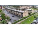Exterior view of the condo complex with parking, green space, and mature palm trees at 150 Harborside Ave # 304, Punta Gorda, FL 33950