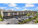 Exterior showcasing the building's facade, parking area, manicured landscaping, and convenient visitor parking at 150 Harborside Ave # 304, Punta Gorda, FL 33950