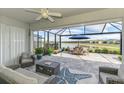 Serene screened-in patio with comfortable seating and picturesque lake views, ideal for relaxation and entertainment at 15033 Spanish Point Dr, Port Charlotte, FL 33981