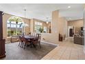 Traditional dining room with a large arched window providing natural light at 1921 Pebble Beach Ct, Venice, FL 34293