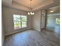 Dining area with large window offering natural light and tile floors at 2201 Como St, Port Charlotte, FL 33948
