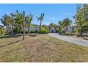 Single-story home with tidy lawn and shrubbery, showing an inviting, well-kept landscape at 2440 Ednor St, Port Charlotte, FL 33952