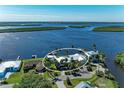 Expansive aerial view showcases the stunning waterfront home with boat dock amidst lush landscaping and serene water views at 3790 Peace River Dr, Punta Gorda, FL 33983