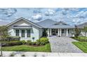 Charming home featuring beautiful landscaping, a metal roof, and a welcoming front porch at 42239 Lake Timber Dr, Punta Gorda, FL 33982