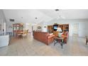 Open-concept living and dining area with tile flooring, vaulted ceilings, and ceiling fans at 494 Monaco Dr, Punta Gorda, FL 33950
